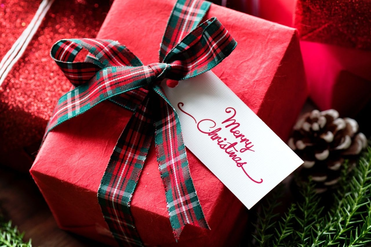 A close-up of a festive Christmas gift with a tag reading “Merry Christmas.”