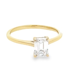 A yellow gold solitaire ring with a lab-grown center diamond.