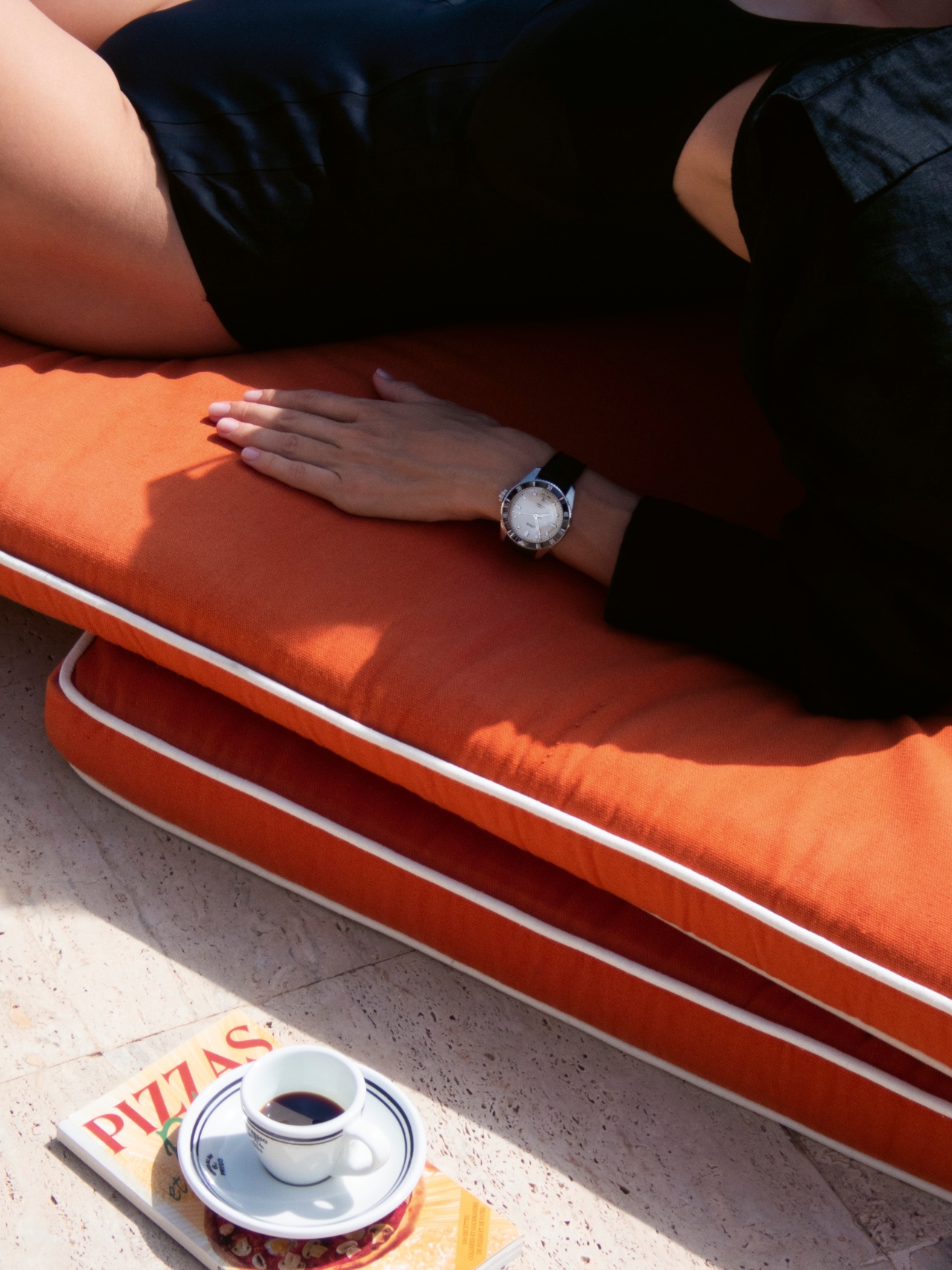 A person wearing the Oris Diver Date watch by the pool