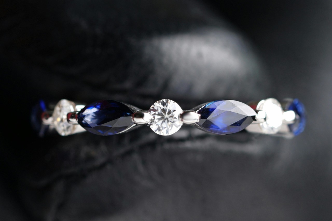 a white gold wedding band featuring diamonds and sapphires