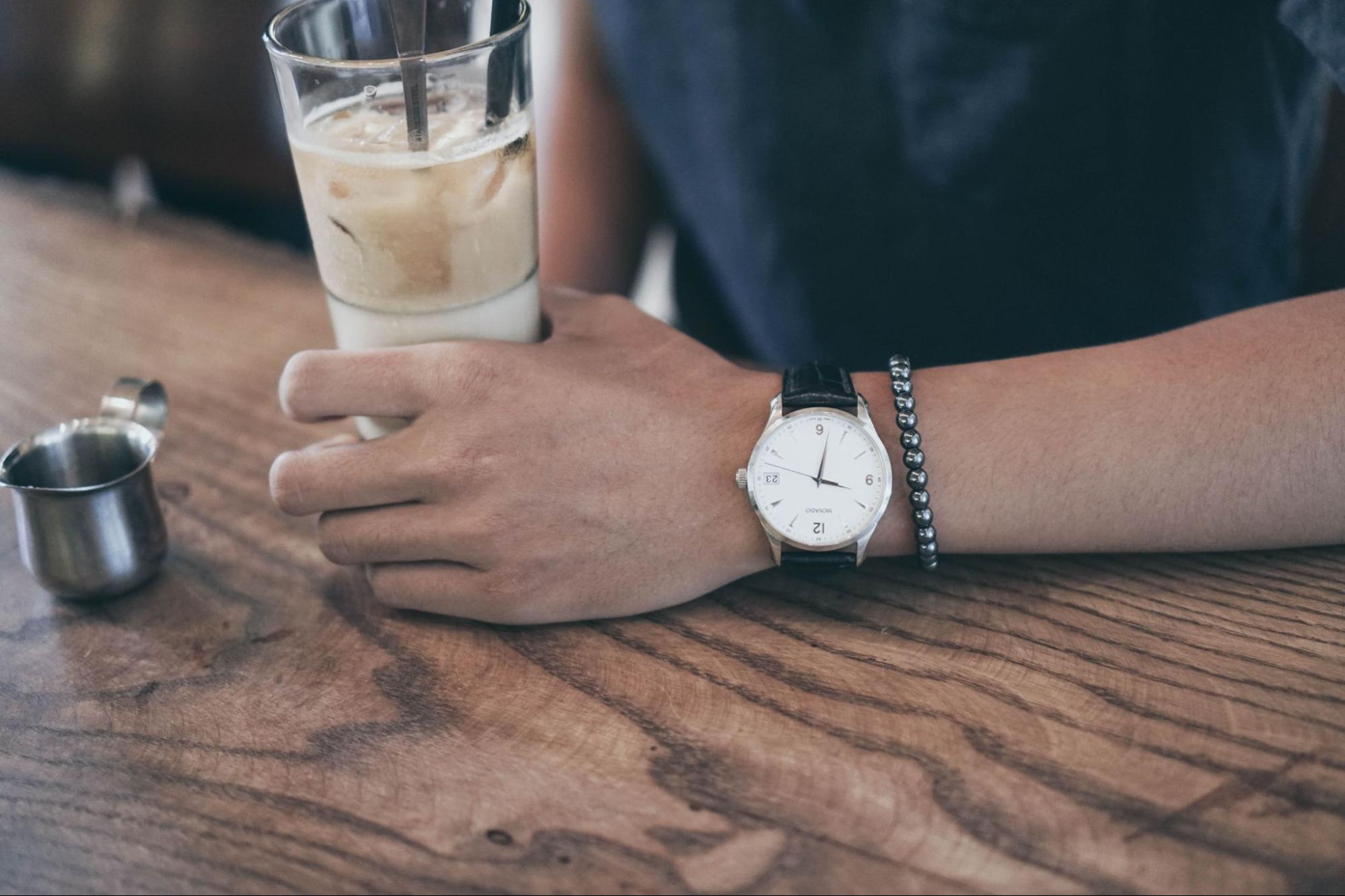 man with watch holding a drink